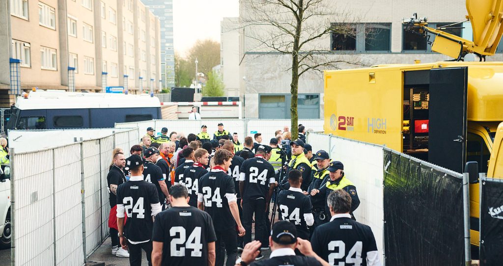 Football team in the middle of police officers during PSV Eindhoven title celebrations