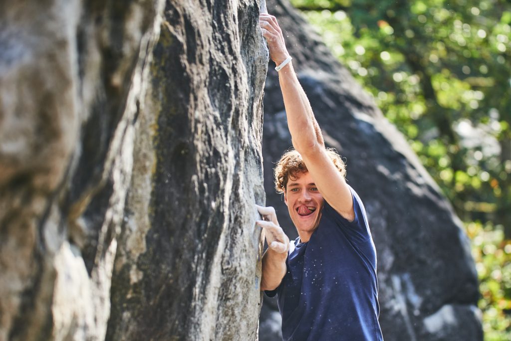Mad Rock athlete Kipras Baltrunas climbing a boulder problem in Fontainebleau