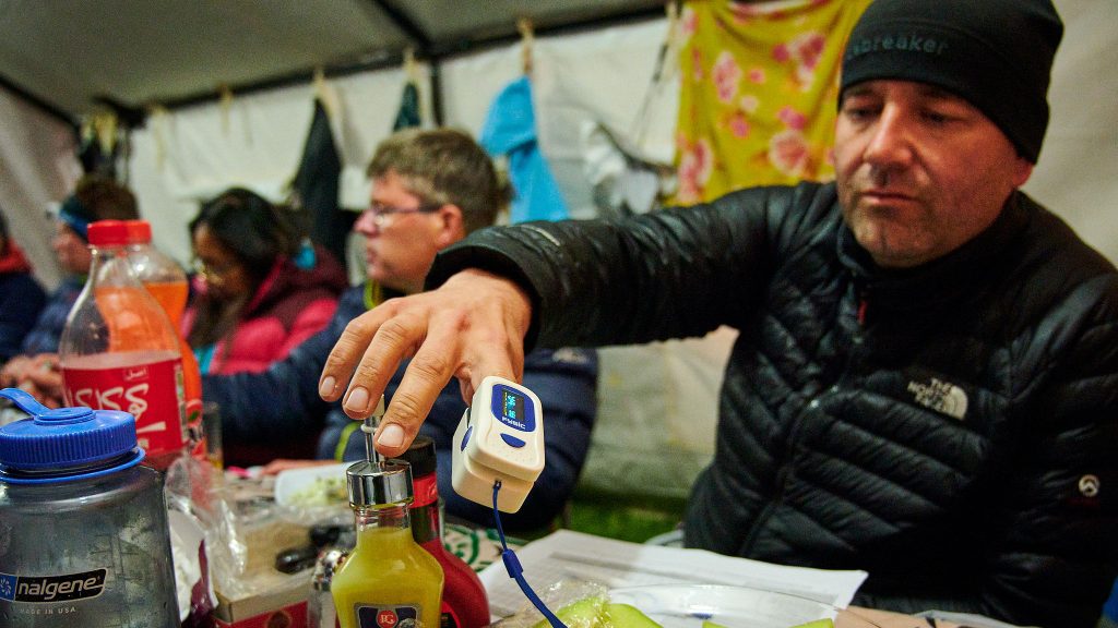 Climber in Iran checking his blood saturation before a summit bid