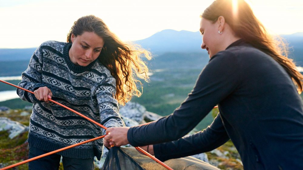 Two women pitching a tent in Norway