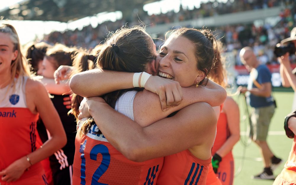Two Dutch national female hockey team players embrace