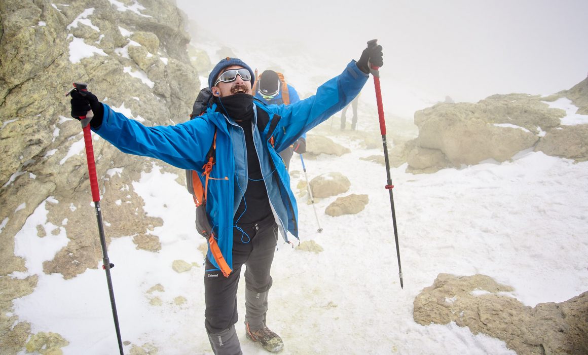 Ecstatic mountaineer on the summit of Mount Damavand in Iran