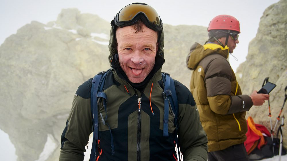 Relieved mountainer on the summit of Mount Damavand in Iran