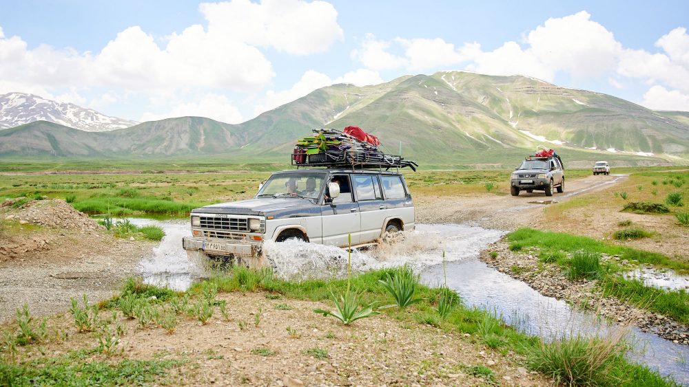 Jeeps carrying alpinists' bags in Dar valley in Iran